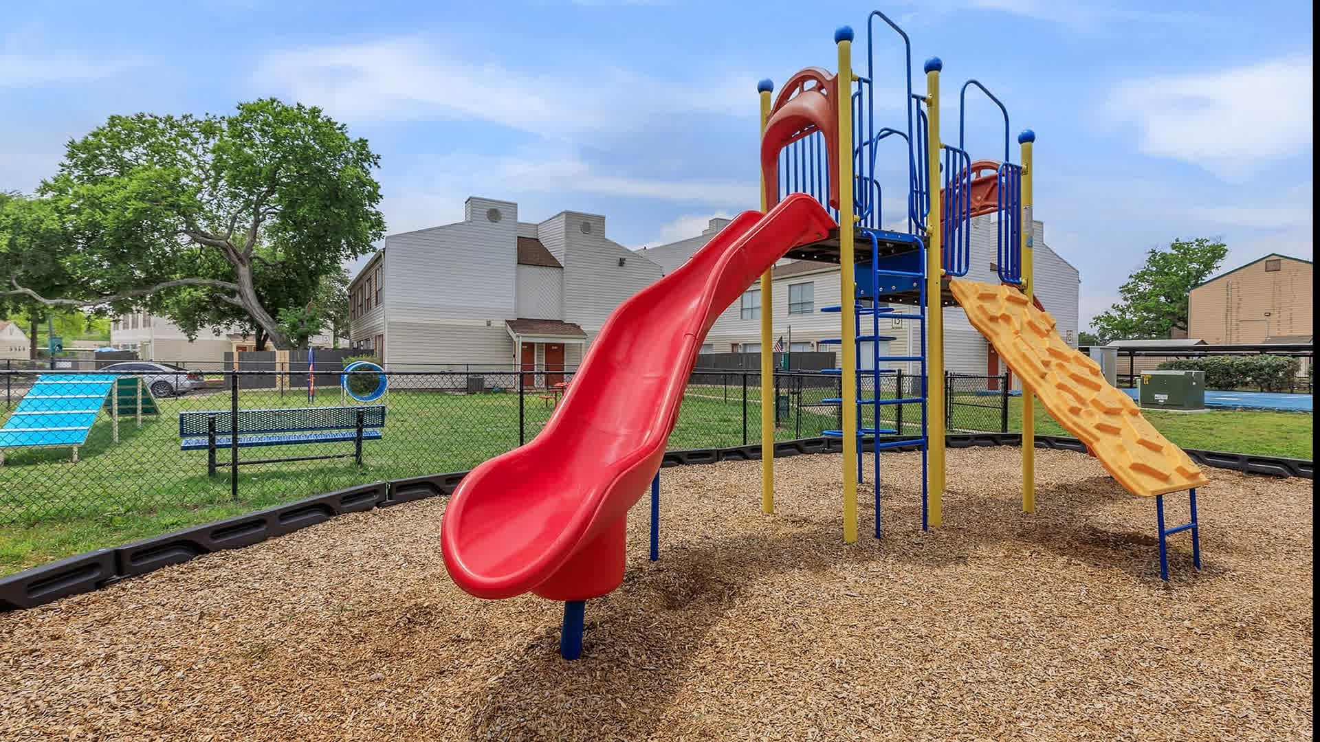 On-site playground with a red slide and climbing wall